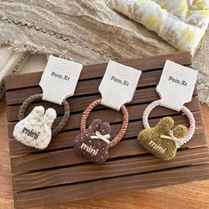 Set di tre elastici per capelli a forma di coniglietto di peluche in tre colori