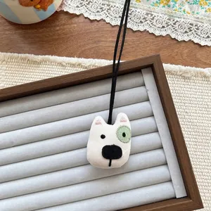 Detail of cute Bull Terrier fabric pendant with fine embroidery and black lanyard cord