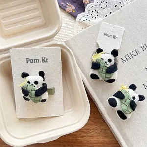 Cute plush panda hair clip with green bamboo shoot detail and metal duckbill clip