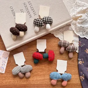 Set of colorful handmade fabric mushroom elastic hair ties with plaid and polka dot patterns