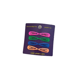Set of 8 colorful teardrop snap hair clips in matte finish on a purple display card