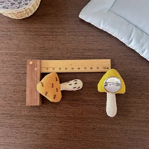 Close-up of handmade mushroom fabric brooches in yellow and brown with safety pins