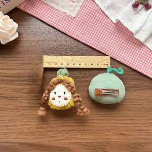 Detail of handmade fruit fabric hair clip with cute character design and metal duckbill clip