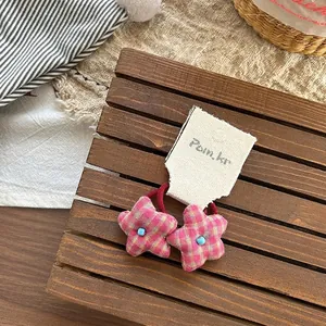 Detail of pink plaid star hair ties with blue beads on high-elastic red rubber bands