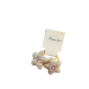 Plaid pattern star hair clips in yellow and blue fabric on a display card