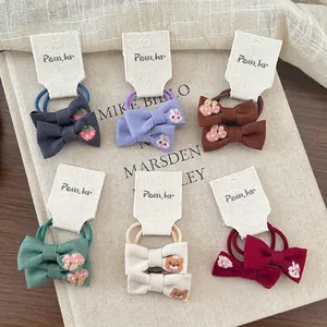 Cartoon embroidered bow hair ties for girls in multiple colors and patterns
