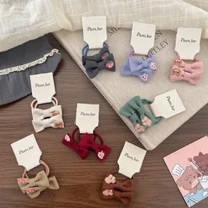 Set of 8 colorful embroidered bow hair ties featuring cute animal and fruit patterns