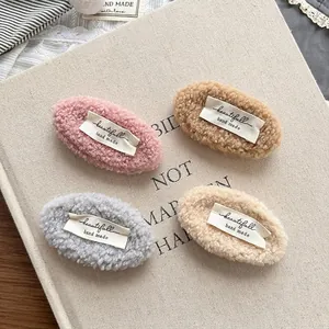 Set mit vier bunten Lammwoll-Haarspangen in Rosa, Kaffee, Grau und Beige-Tönen