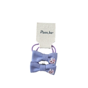 Pair of purple fabric bow hair ties with cute rabbit embroidery for kids on white card