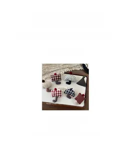 Handmade fabric mushroom brooches with checkered patterns and pom-pom detail