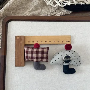Handmade fabric brooch pins featuring red checkered and polka dot patterns with pom-poms
