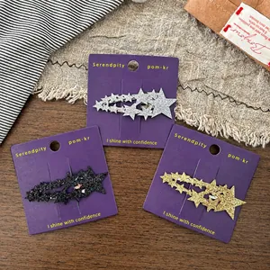 Dreiteiliges Set glitzernder sternförmiger Haarklammern in Silber, Schwarz und Gold