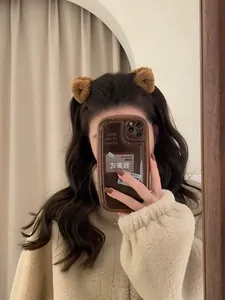 Détail d'une adorable pince à cheveux oreilles d'ours en peluche marron en laine d'agneau