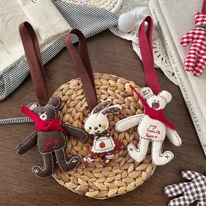 Handmade fabric bear and bunny pendants set with embroidered ribbons and rustic aesthetic