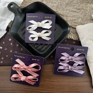 Three-color velvet bow hair clip set for girls on a vintage decorative background
