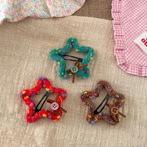 Handmade knitted star hair clips in mint, red, and brown with mini bow details