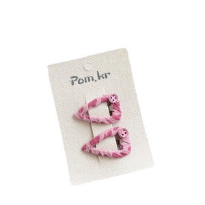 Pink heart pattern fabric hair clips with button detail on white display card