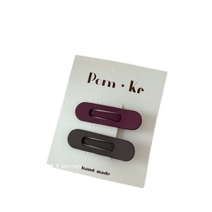 Matte finish water drop hair clips in purple and taupe on white display card