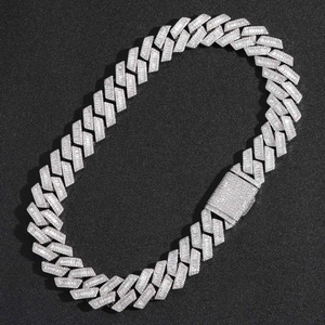 Close-up of 20mm Cuban chain with baguette and round zircons on a black surface