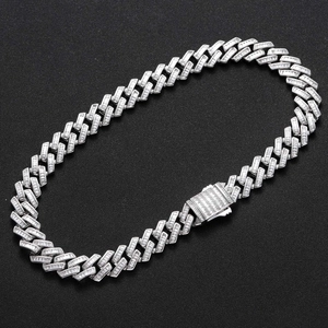 Detailed close-up of 16mm silver cuban link chain with iced out baguette-cut zircons