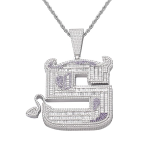 Close-up of iced-out silver S-letter demon pendant with purple and white cubic zirconia
