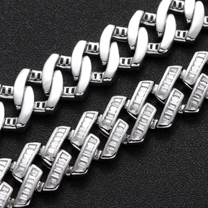 Macro shot of 16mm baguette-cut zircon Cuban link chain with polished silver links