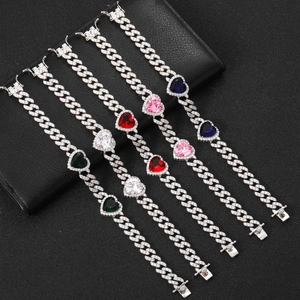 Macro detail of silver Cuban link bracelets with vibrant heart-shaped zircon stones