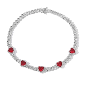 Detail of 9mm Cuban link necklace with heart-shaped red zircon and sparkling pavé stones
