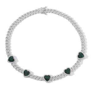 Detail of silver Cuban chain necklace with green heart-shaped zircons and micro pave setting