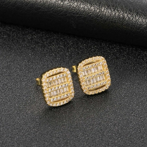 Macro shot of hip hop square stud earrings with gold plating and baguette-cut cubic zirconia