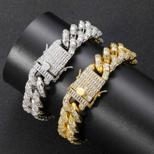 Detail of 16mm gold and silver baguette-cut cubic zirconia iced out Cuban link bracelets
