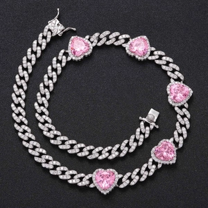 Detailed view of Cuban chain with pink heart gemstone and sparkling pavé zircons