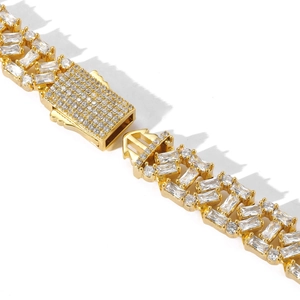 Detailed macro view of 13mm gold Cuban link chain featuring rectangle and round cut zircons