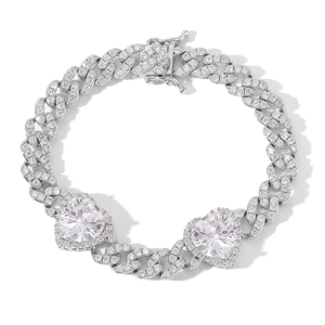 Macro view of silver Cuban link bracelet with sparkling white heart-shaped zircons