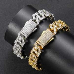 Macro view of 13mm iced out Cuban link bracelets in gold and silver with square cut stones