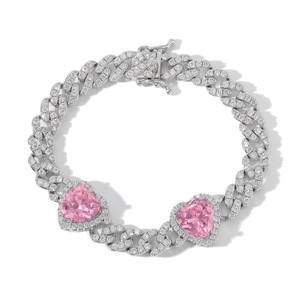 Macro view of silver Cuban chain bracelet featuring pink heart stones and clear cubic zirconia
