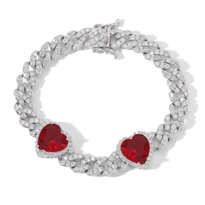 Close-up of silver Cuban chain featuring heart shaped red zircons and white crystals