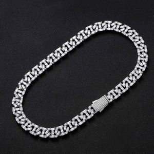 Macro shot of 13mm iced out silver cuban chain featuring baguette cut diamonds