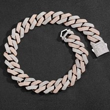 Macro view of two-tone silver and rose gold Cuban chain with pave-set cubic zirconia stones