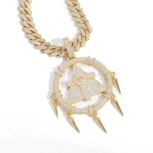 Detail view of hip hop gold pendant with Cuban chain and cubic zirconia pyramid eye