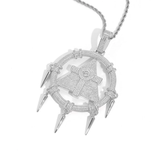 Detail of silver hip hop pendant with cubic zirconia inlay and conical tassels