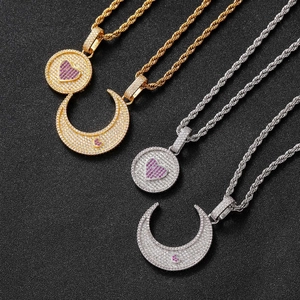 Détail de pendentifs hip-hop soleil et lune avec zircons micro-pavés et chaînes torsadées