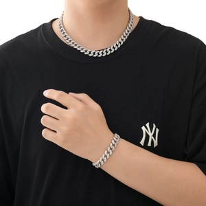 12mm silver Cuban link chain necklace with micro-paved zircons worn by a male model