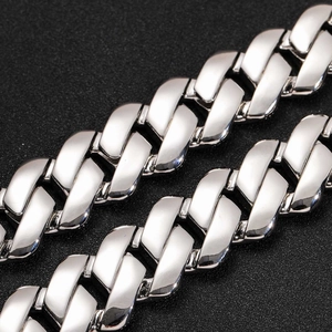 Macro shot of polished silver Cuban chain links with high mirror finish in hip-hop style