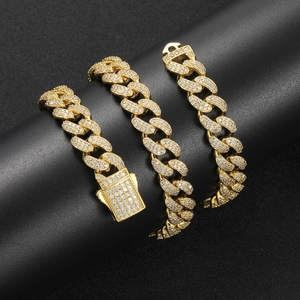 Macro shot of 12mm gold Cuban link chain with micro-pave zircons and spring buckle