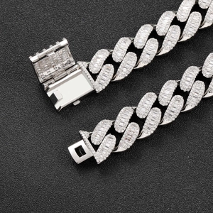 Macro detail of silver-tone 15mm Cuban link chain with baguette-cut zircon stones