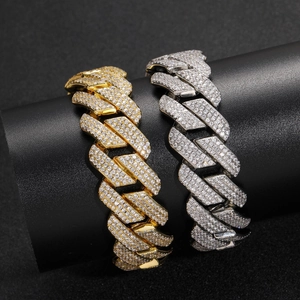 Macro detail of 20mm Cuban link chains with triple row zircon pave in gold and silver