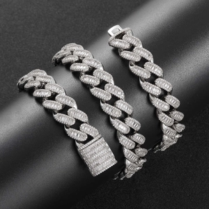 Macro view of 15mm silver Cuban link necklace featuring baguette-cut zircon stones