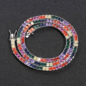 Macro detail of square-cut rainbow zircon tennis chain with secure silver closure
