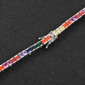 Macro detail of rainbow square zircon tennis bracelet with silver metal fold-over clasp